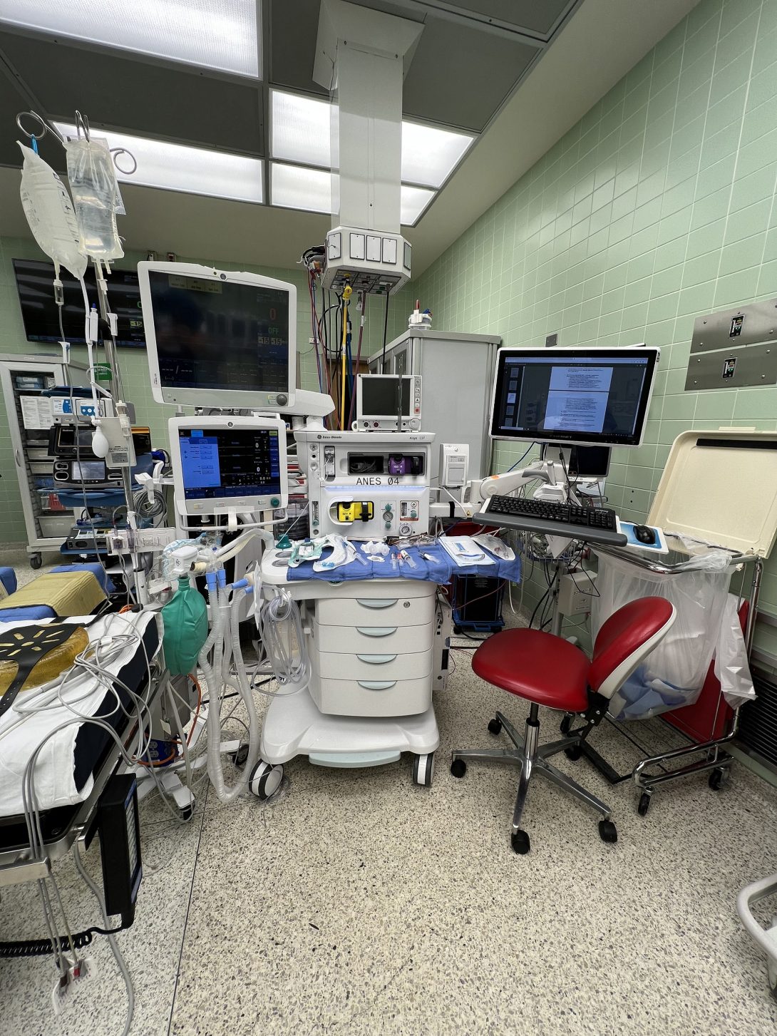 Anesthesia cart, vitals, and IV bag hangers on wheels during Pre-Op